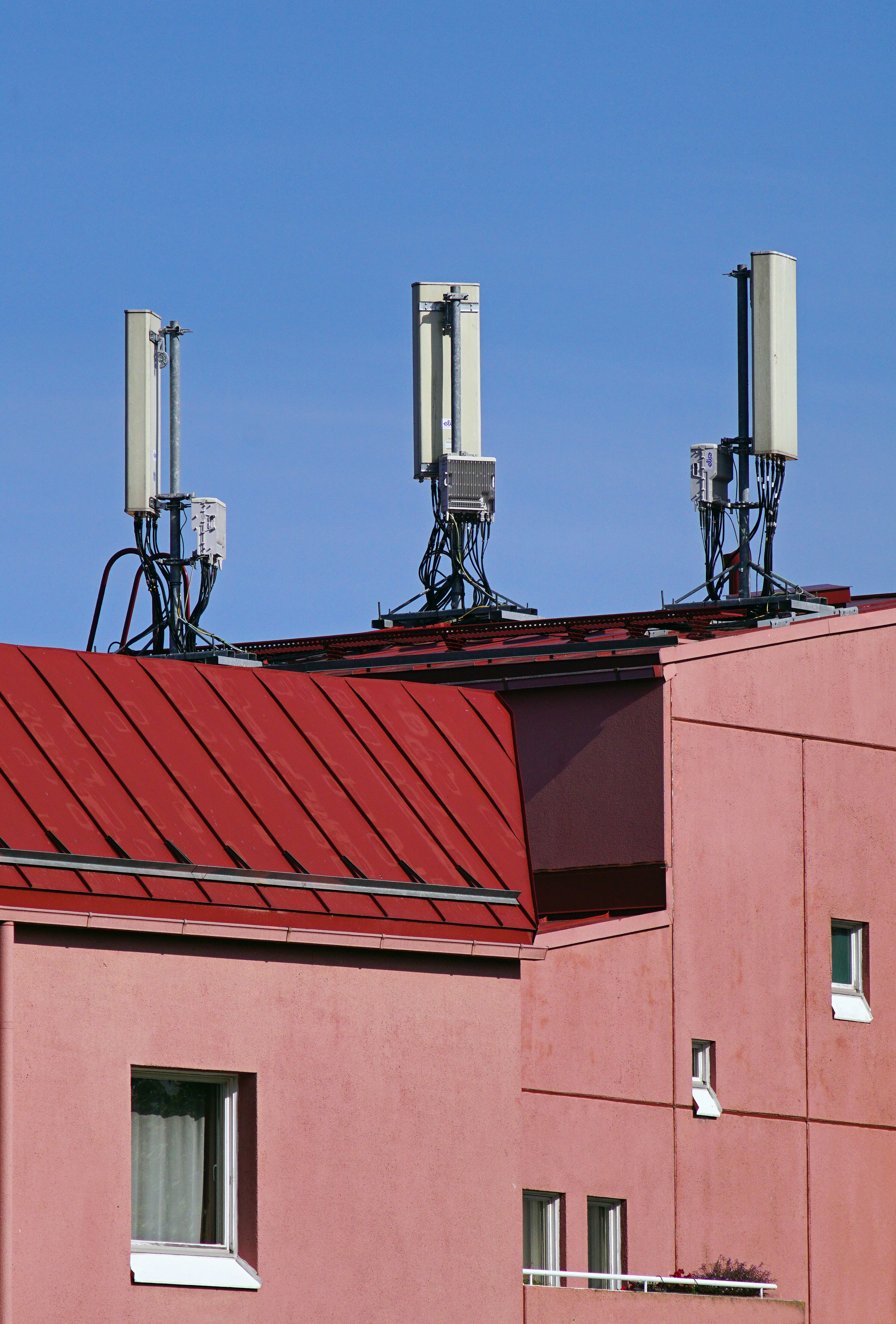 Cell antennas on an apartment rooftop — urban infrastructure like this is installed on buildings everywhere