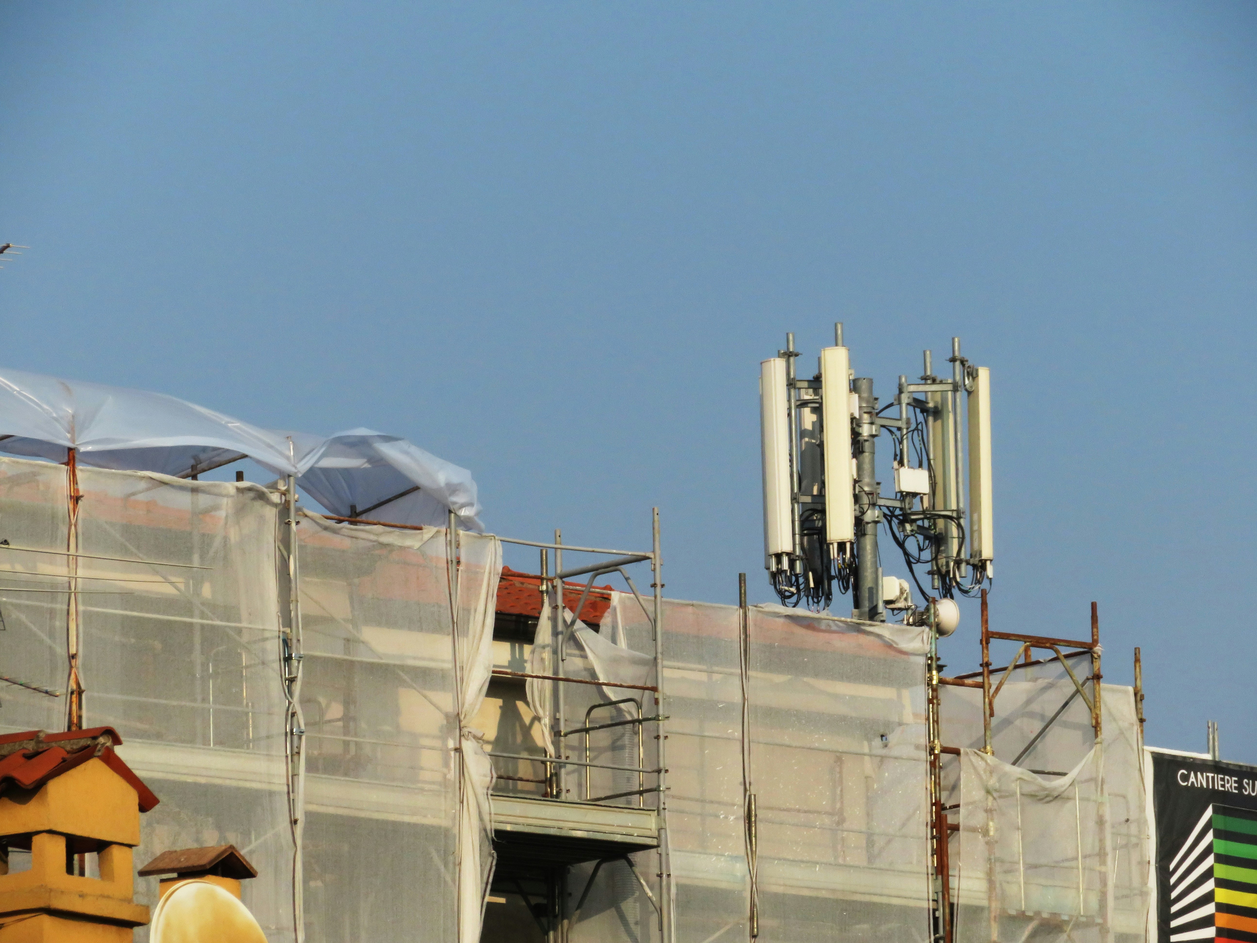 Cell antennas on an urban building under construction — cell infrastructure is being added to buildings everywhere